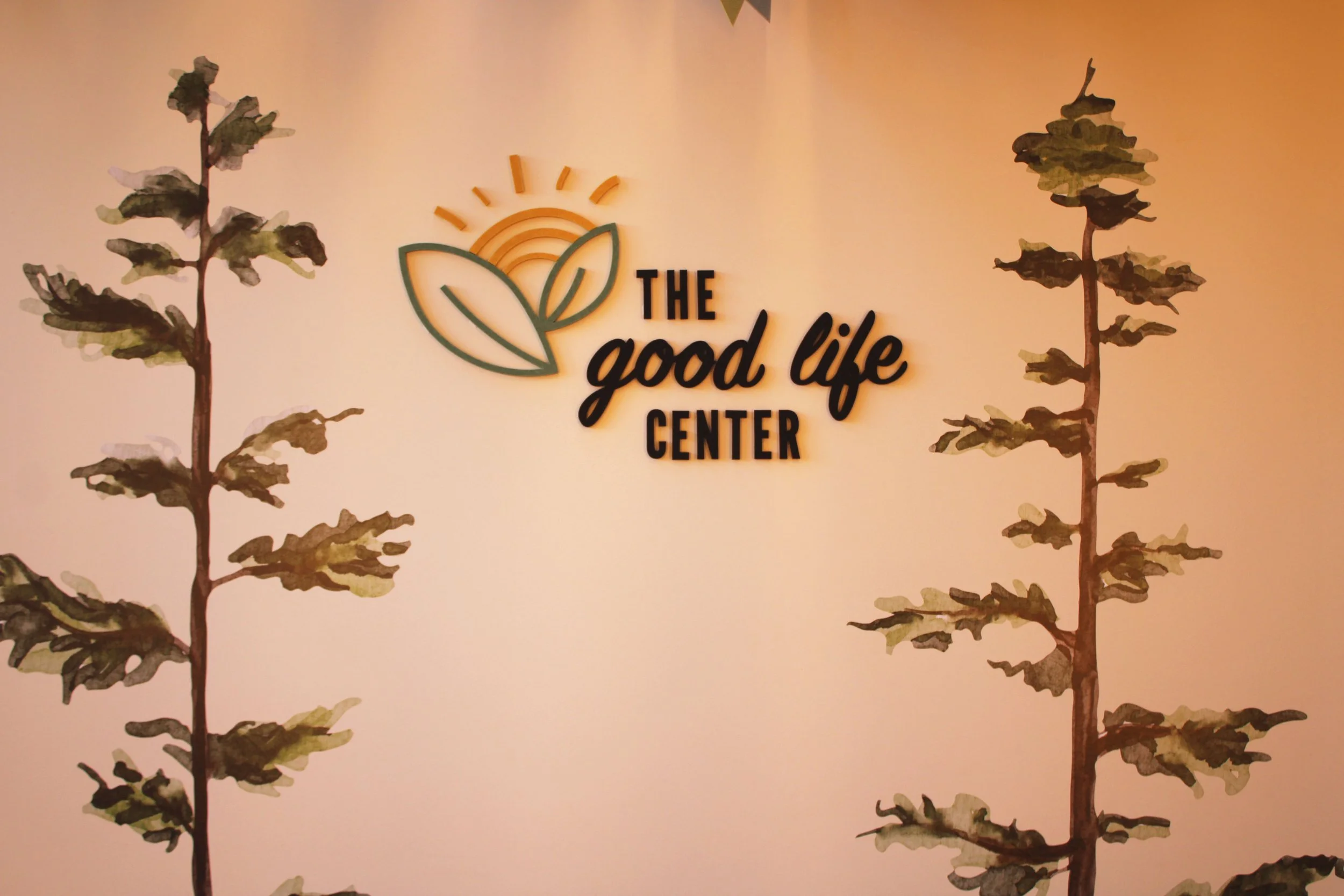 Entrance "The Good Life Center" logo wall